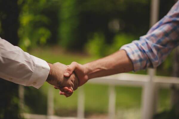 Fprobate real estate agent shaking hands with client
