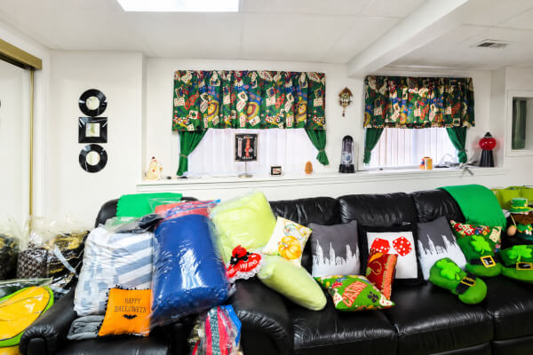 A room packed with personal belongings inside an inherited house in Illinois being organized by an estate sale vendor