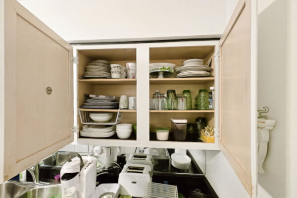 Kitchenware inside an inherited house in Illinois being organized by an estate sale vendor